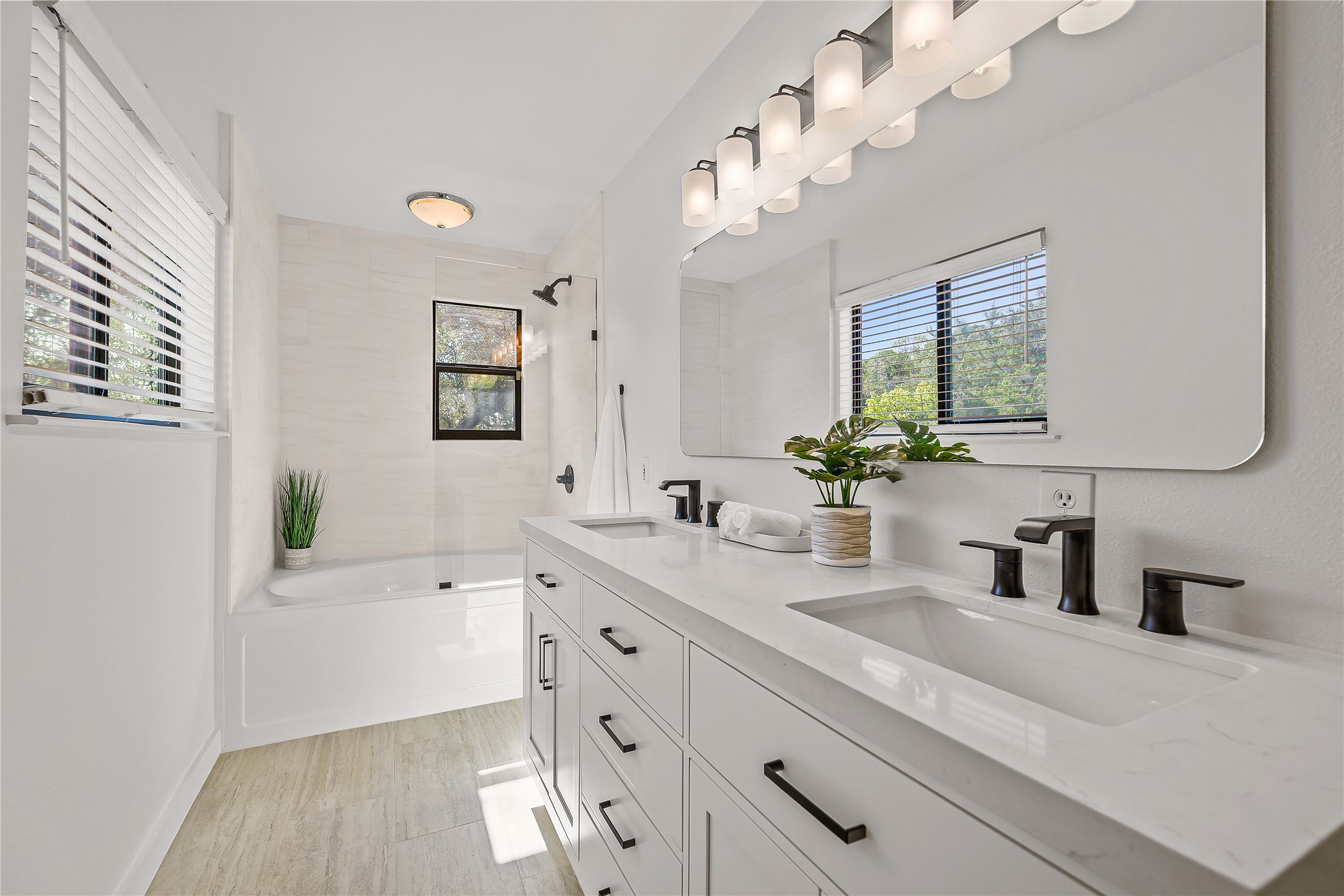 19645 Lakehurst Loop Spicewood, TX 78669 - Photo 29 of 40 Full bath with double vanity, healthy amount of natural light, light wood-type flooring, and bathtub / shower combination