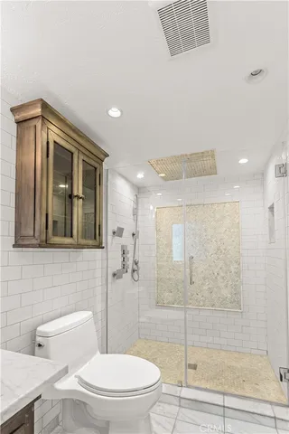 a bathroom with a toilet a sink and shower