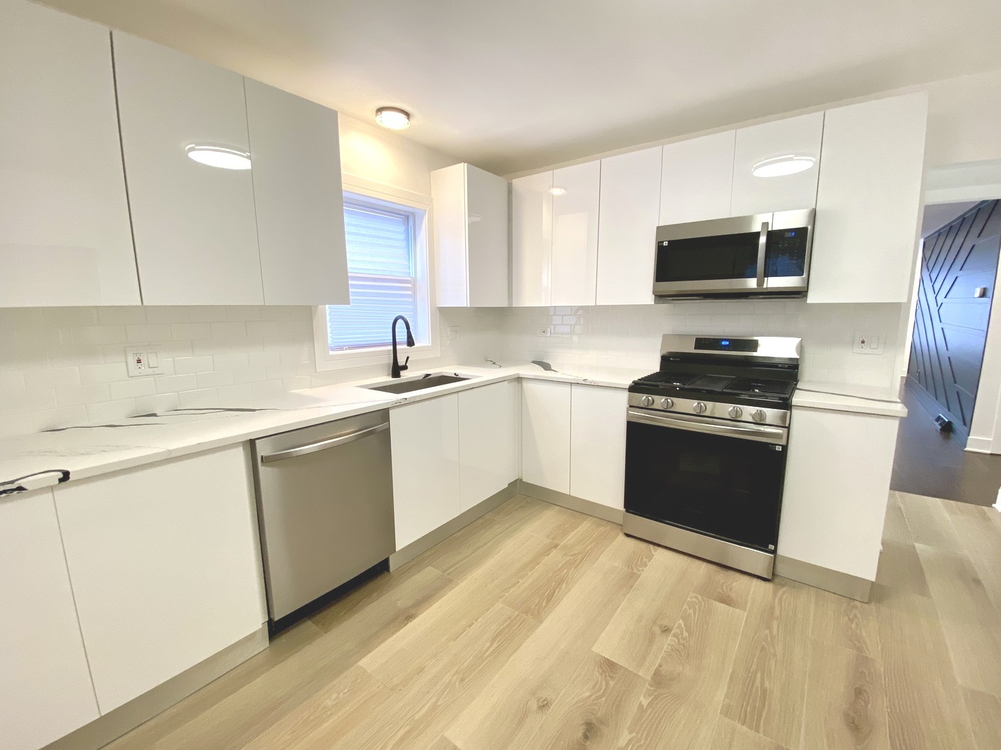 Undisclosed Address Chicago, IL 60617 - Photo 15 of 29 a kitchen with granite countertop a sink cabinets and stainless steel appliances