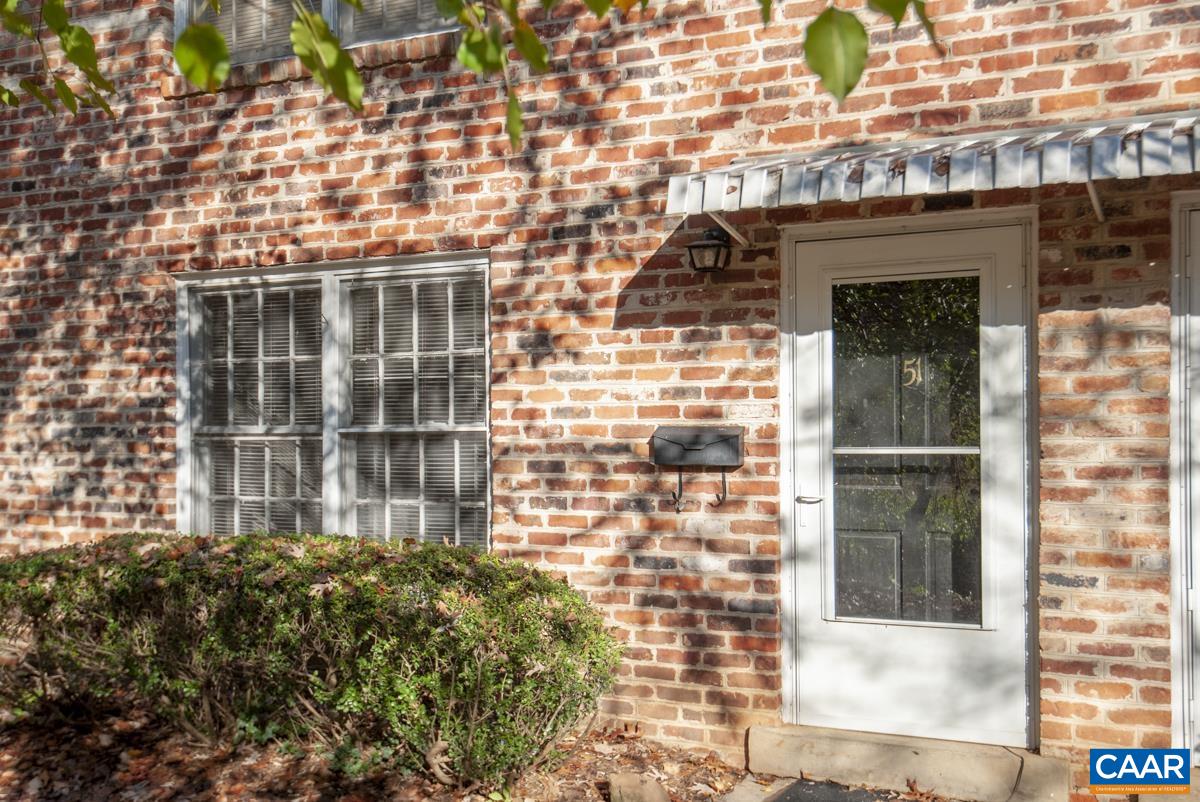 2527 Hydraulic Road, Unit 51 Charlottesville, VA 22901 - Photo 1 of 18 a front view of a building with a garden