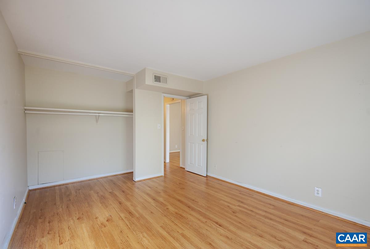 2527 Hydraulic Road, Unit 51 Charlottesville, VA 22901 - Photo 11 of 18 a view of an empty room with wooden floor