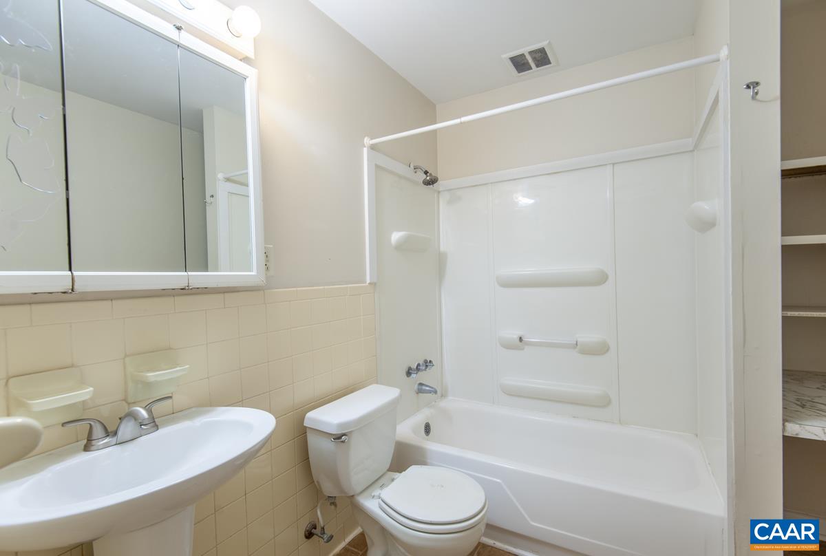 2527 Hydraulic Road, Unit 51 Charlottesville, VA 22901 - Photo 12 of 18 a bathroom with a sink toilet and shower