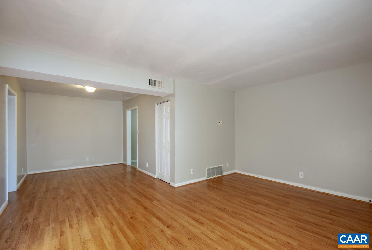 2527 Hydraulic Road, Unit 51 Charlottesville, VA 22901 - Photo 5 of 18 a view of empty room with wooden floor