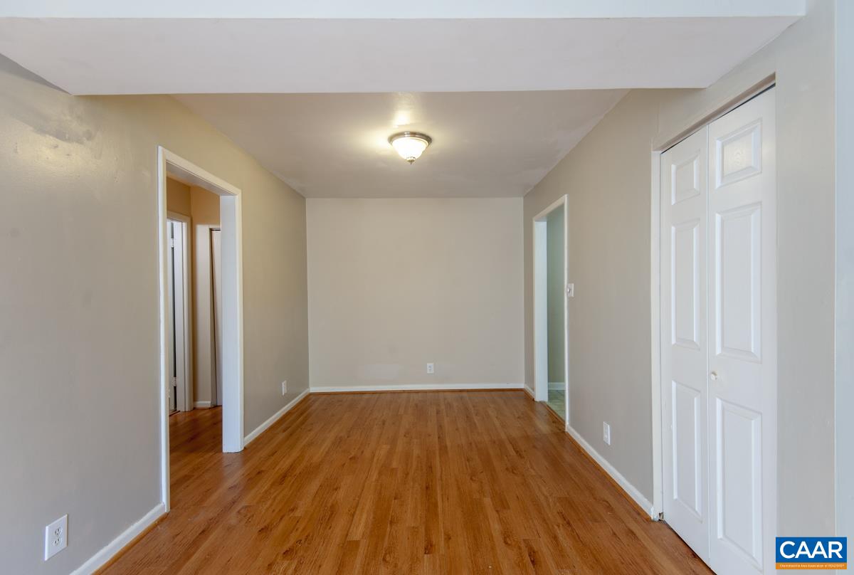2527 Hydraulic Road, Unit 51 Charlottesville, VA 22901 - Photo 6 of 18 wooden floor in an empty room with a window