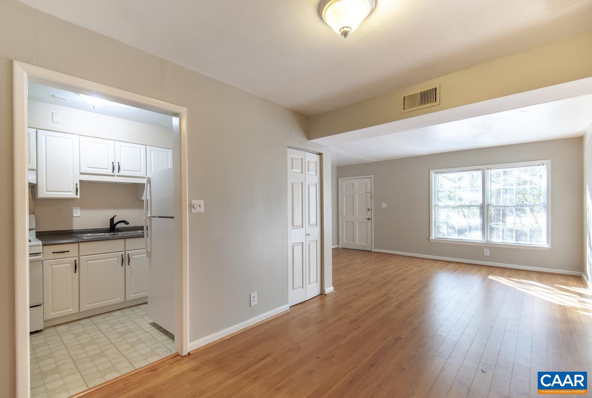 2527 Hydraulic Road, Unit 51 Charlottesville, VA 22901 - Photo 7 of 18 a kitchen with stainless steel appliances granite countertop a stove and a refrigerator