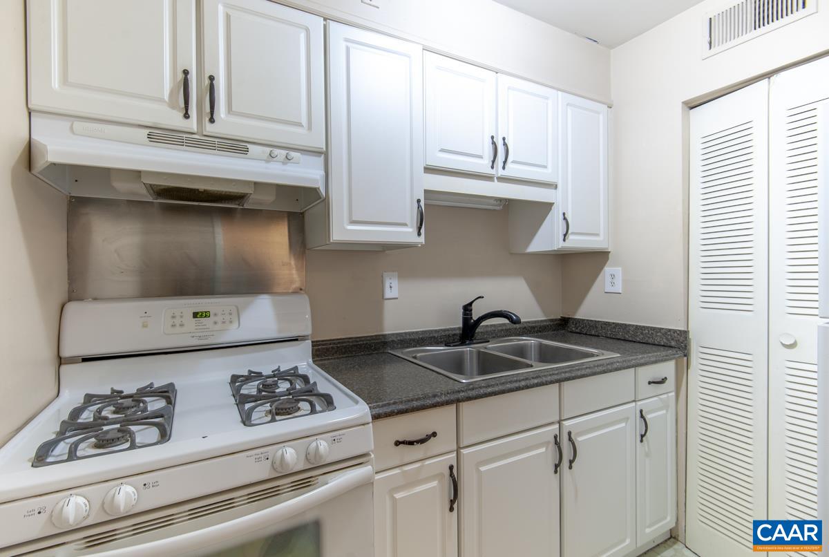 2527 Hydraulic Road, Unit 51 Charlottesville, VA 22901 - Photo 9 of 18 a kitchen with a stove and cabinets