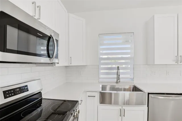 a kitchen with a stove and a microwave