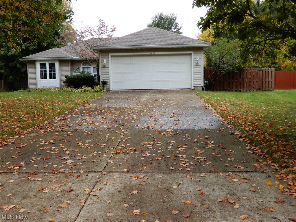 1168 Dock Road Madison, OH 44057 - Photo 2 of 35 Front of home and cement driveway leading to 2 car garage