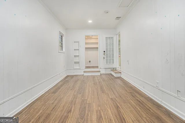 wooden floor in an empty room with a window