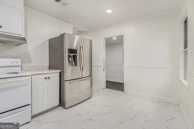a kitchen with cabinets and stainless steel appliances