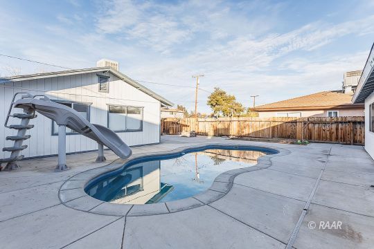 640 Sydnor Avenue Ridgecrest, CA 93555 - Photo 7 of 28 a swimming pool with outdoor seating and stairs