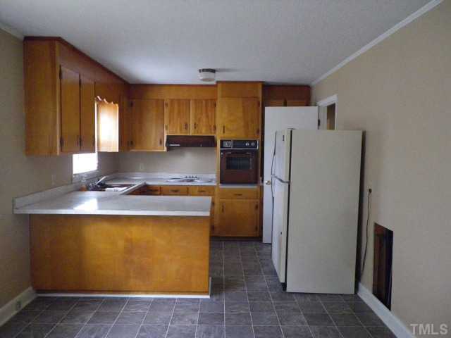 564 Wayview Road Henderson, NC 27537 - Photo 3 of 13 Kitchen with eat at counter and open to the dining area