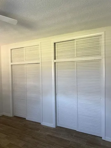 a view of a room with wooden floor