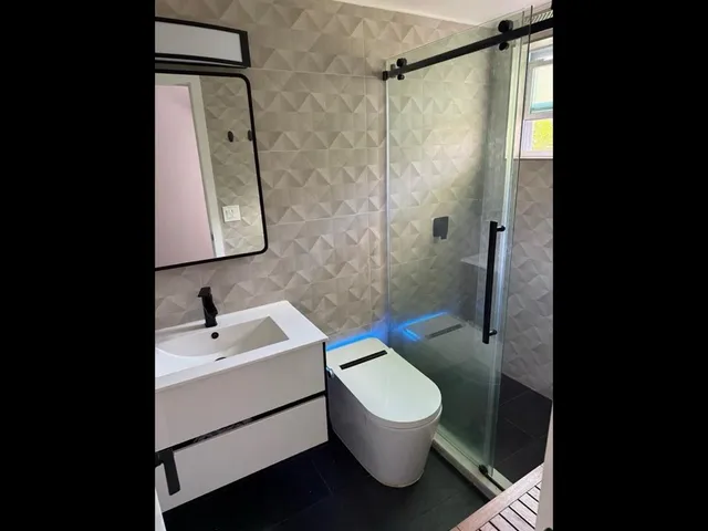 a bathroom with a sink toilet and shower