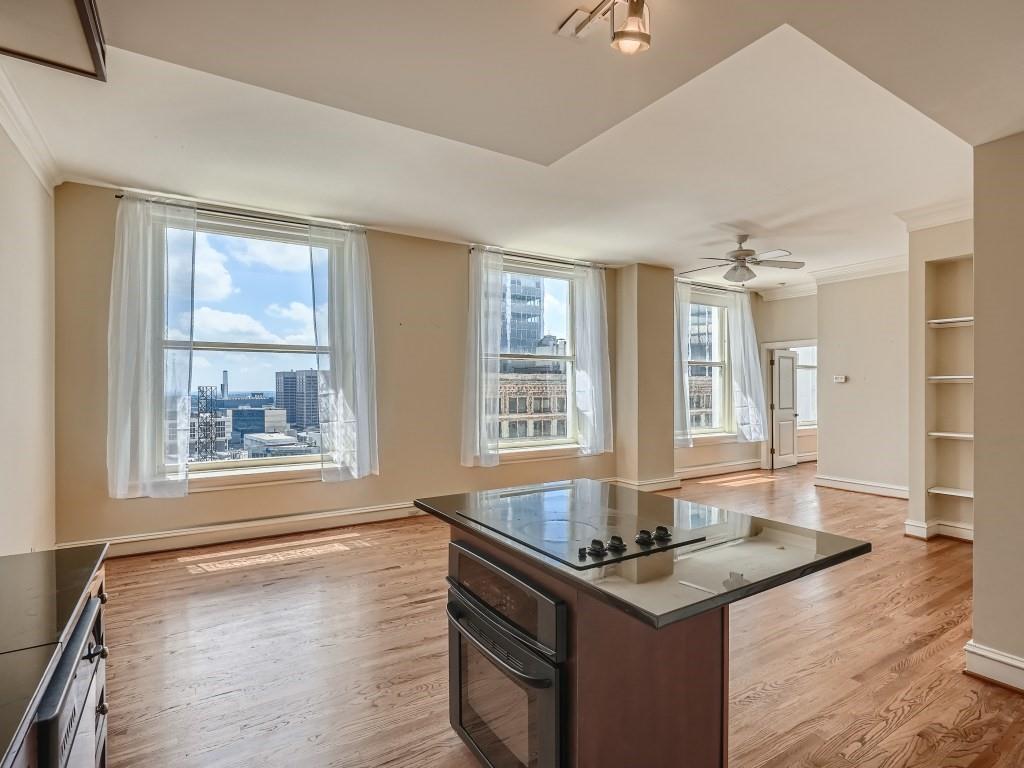57 Forsyth Street Northwest, Unit 14G Atlanta, GA 30303 - Photo 1 of 1 a kitchen with stainless steel appliances granite countertop a sink stove and cabinets