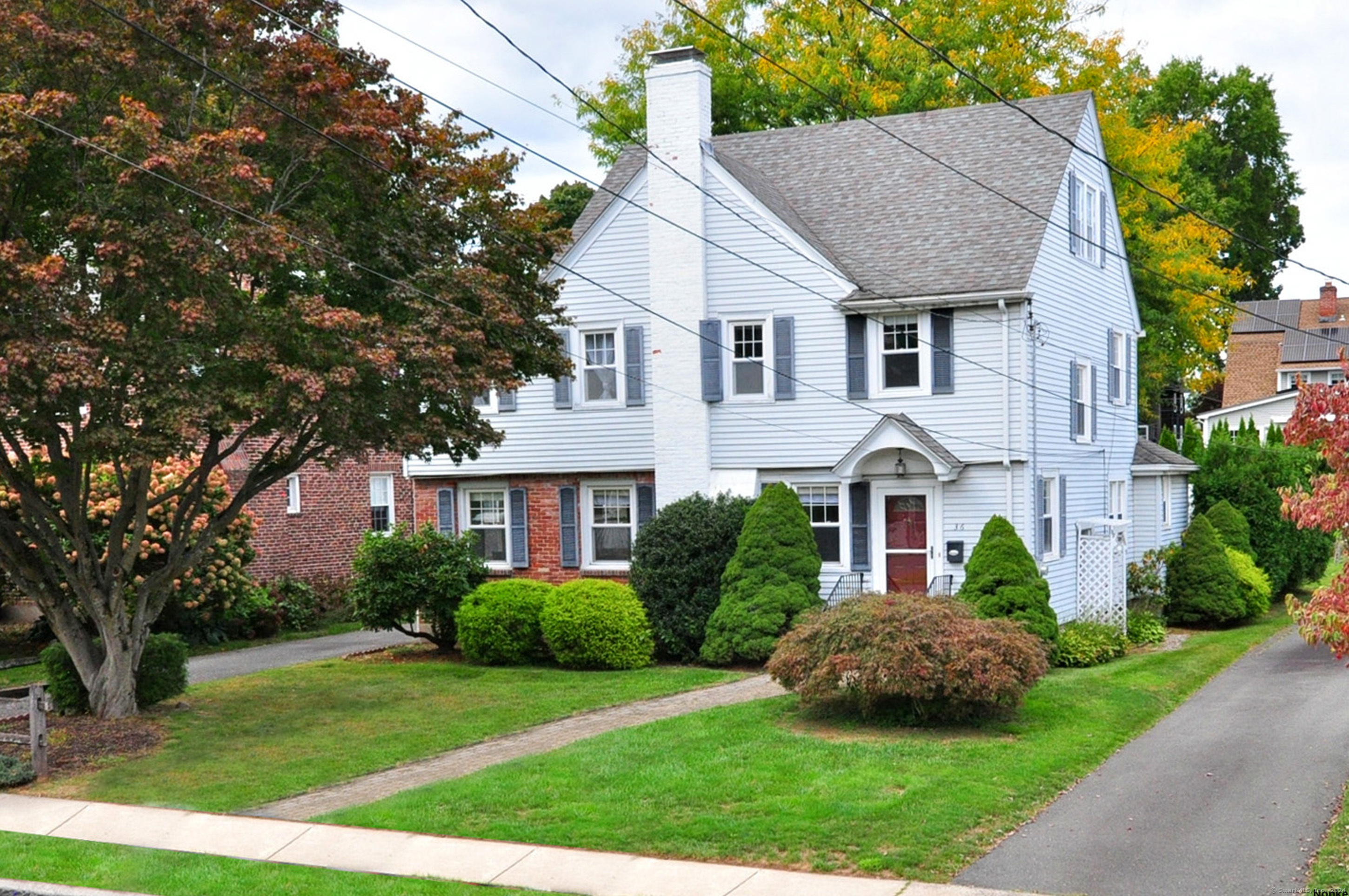 36 Ellsworth Road West Hartford, CT 06107 - Photo 1 of 1 a front view of a house with a garden and plants