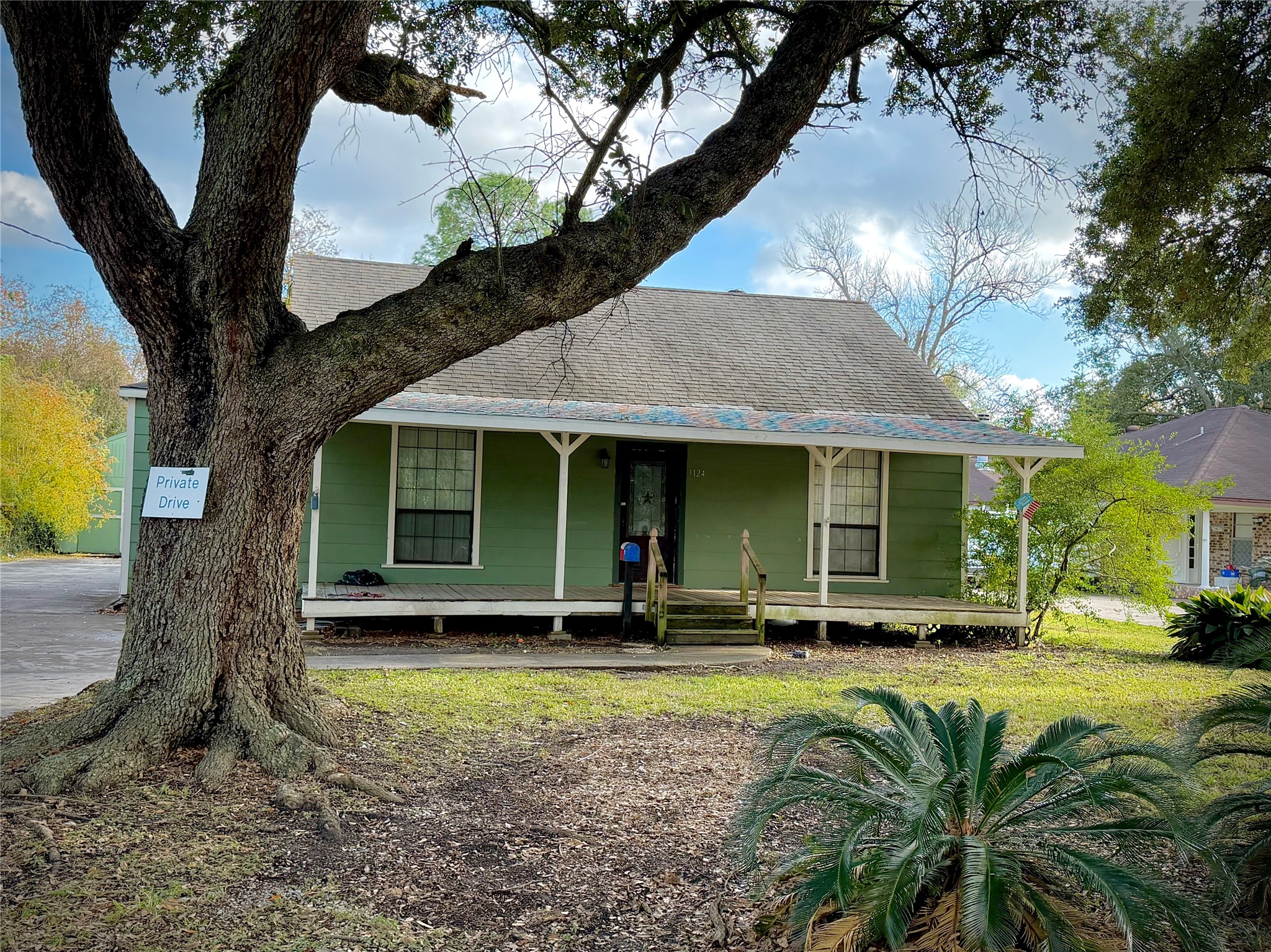 3124 30th Street Port Arthur, TX 77642 - Photo 1 of 25 a front view of a house with a yard table and chairs