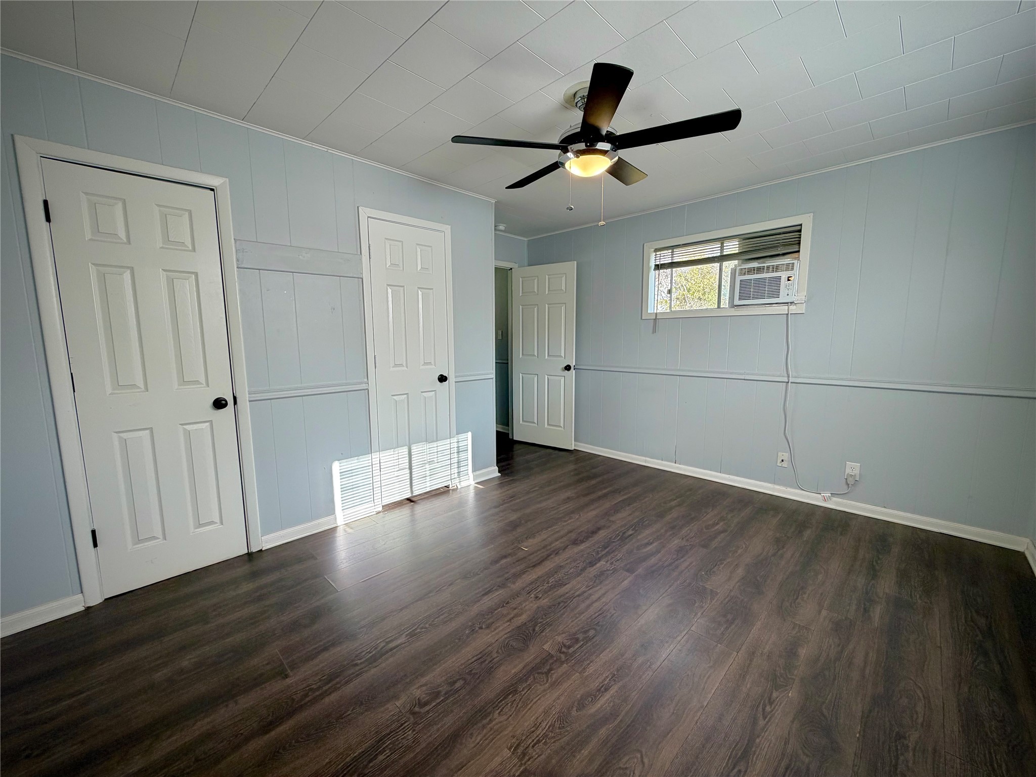 3124 30th Street Port Arthur, TX 77642 - Photo 18 of 25 a view of a livingroom with wooden floor and a ceiling fan