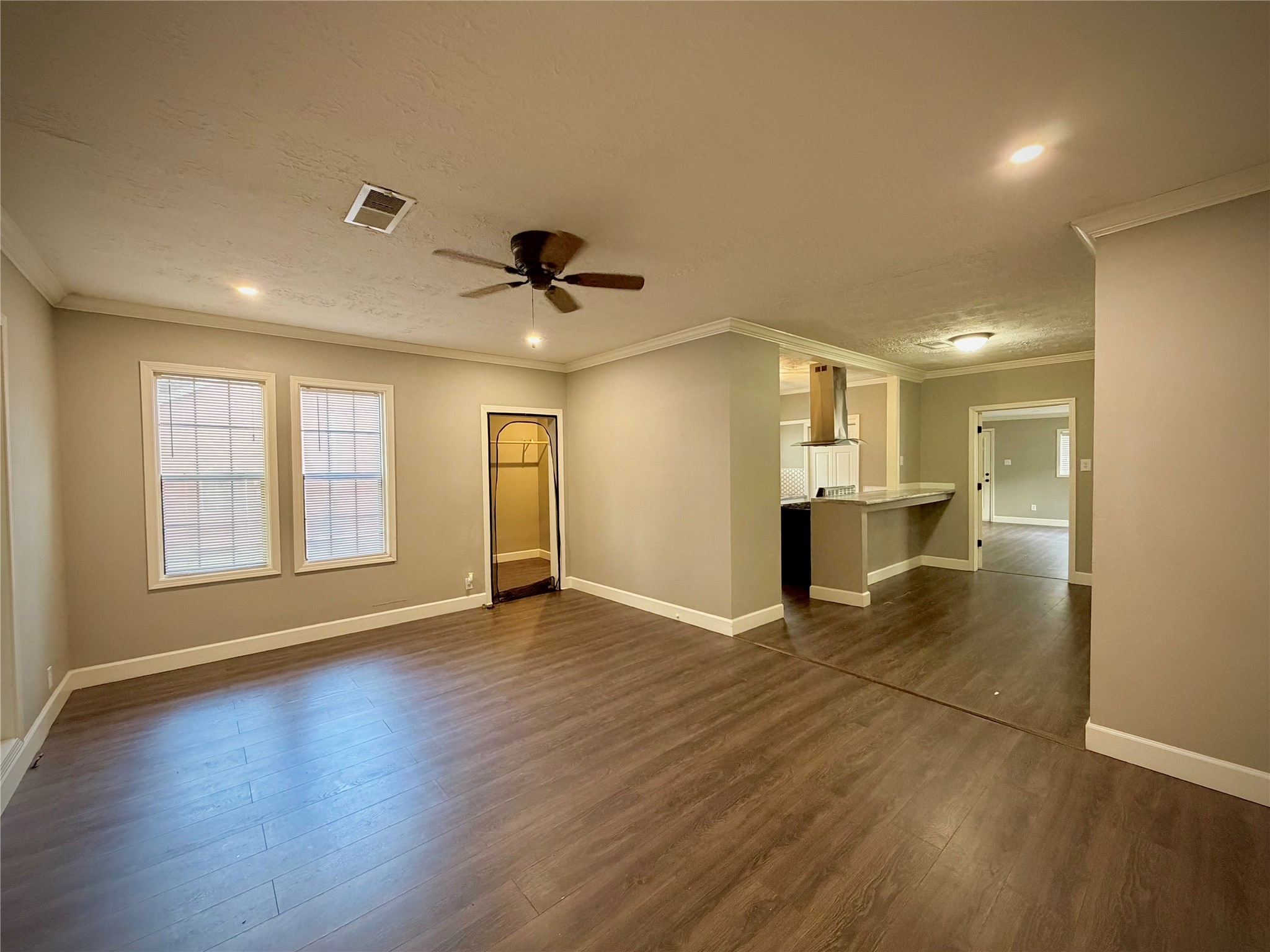3124 30th Street Port Arthur, TX 77642 - Photo 2 of 25 a view of an empty room with a window and wooden floor