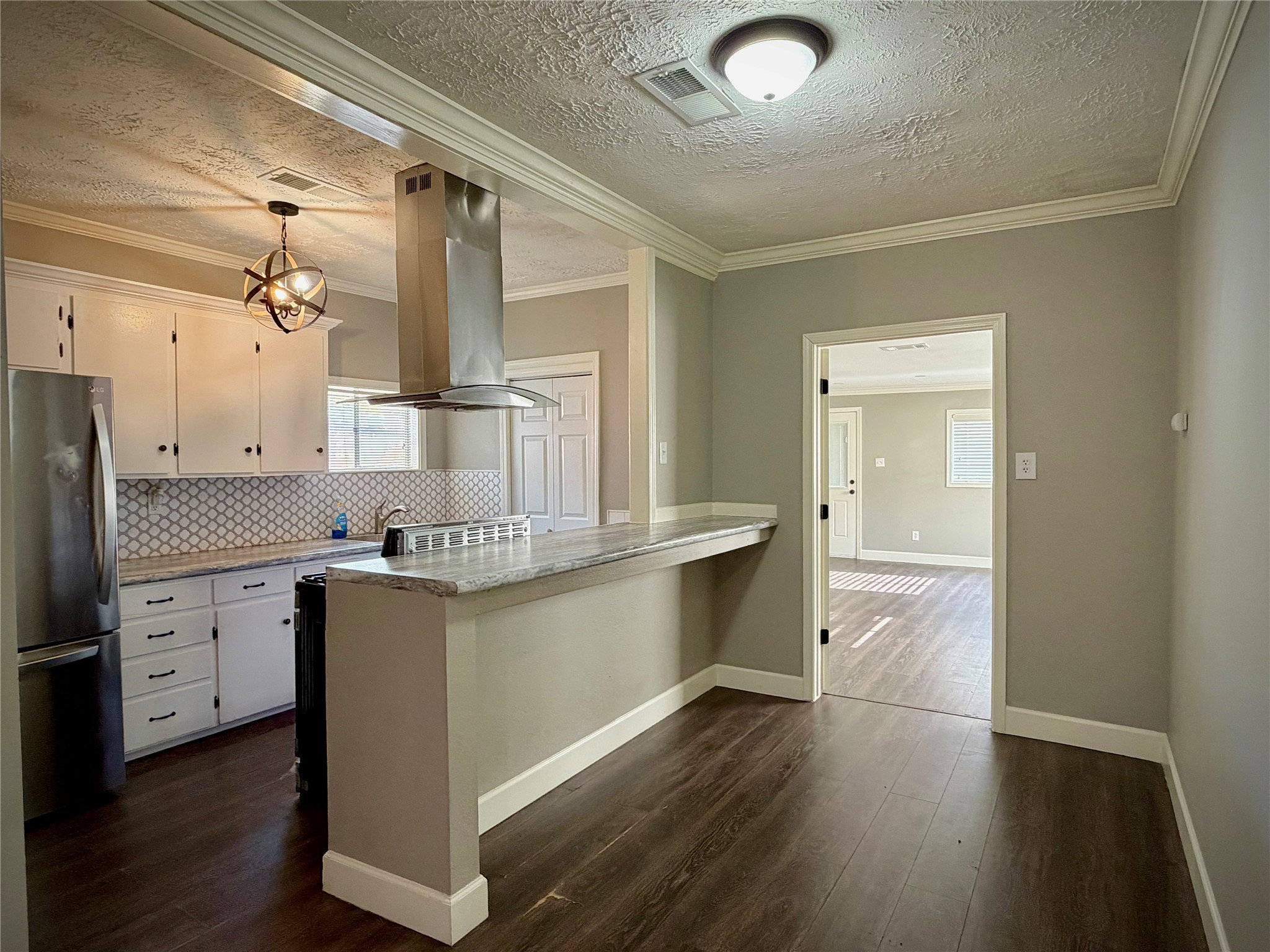 3124 30th Street Port Arthur, TX 77642 - Photo 3 of 25 a kitchen with stainless steel appliances granite countertop a sink stove and refrigerator