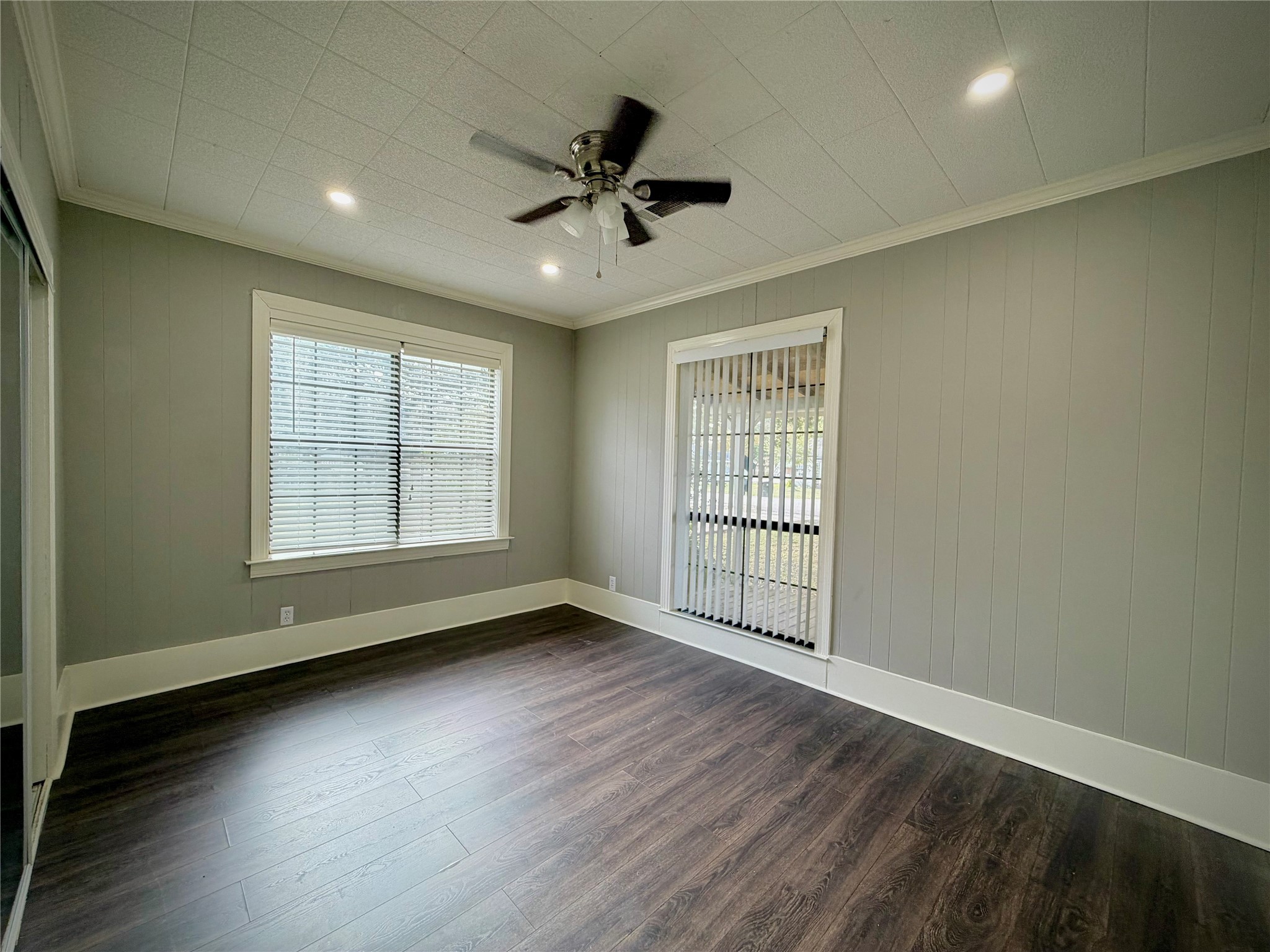 3124 30th Street Port Arthur, TX 77642 - Photo 10 of 25 an empty room with wooden floor chandelier fan and windows