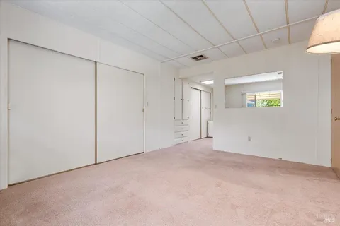 a view of an empty room and a window