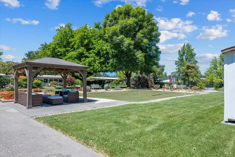 a front view of house with yard swimming pool and outdoor seating
