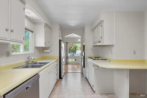a kitchen with a sink stove and cabinets