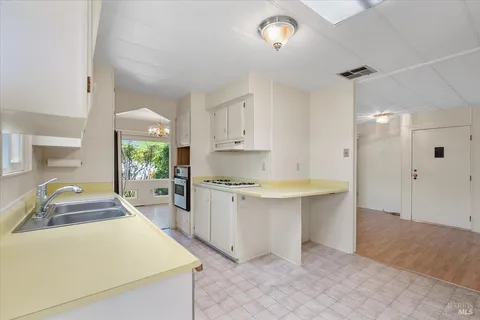 a large kitchen with kitchen island a sink stainless steel appliances and cabinets