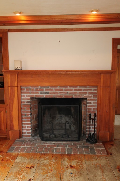 340 Still River Road Harvard, MA 01451 - Photo 2 of 13 a fireplace with a sitting space and a fireplace