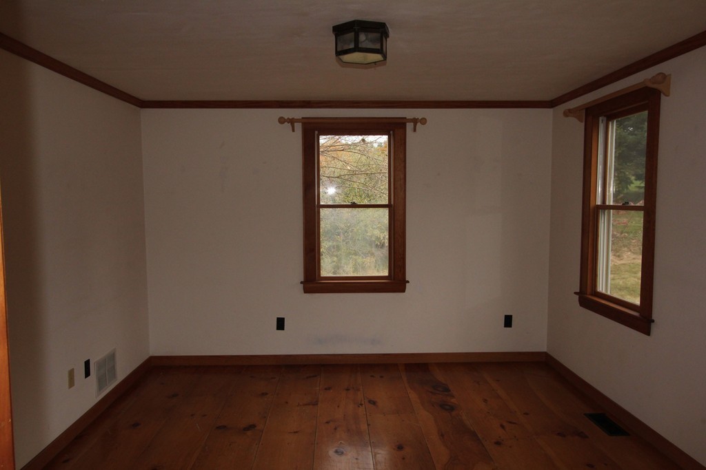340 Still River Road Harvard, MA 01451 - Photo 6 of 13 a view of an empty room with wooden floor and a window