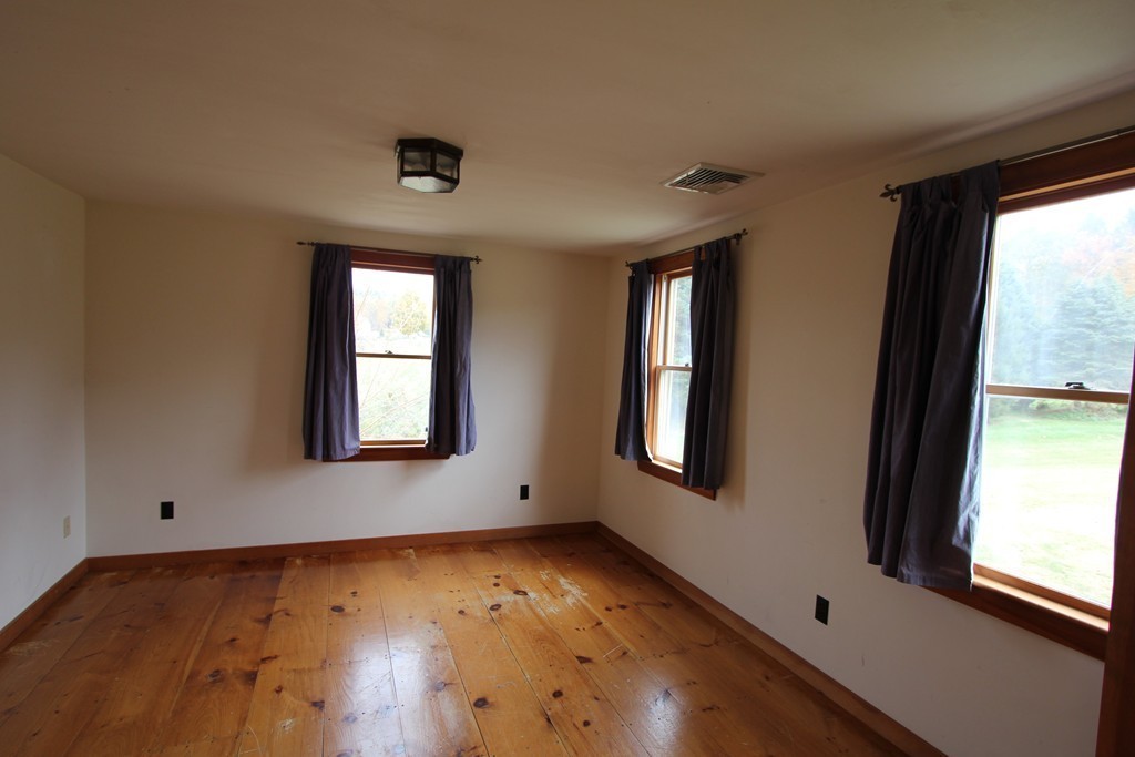 340 Still River Road Harvard, MA 01451 - Photo 10 of 13 a view of an empty room with wooden floor and a window