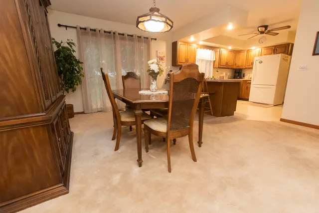 a view of a dining room with furniture and a chandelier