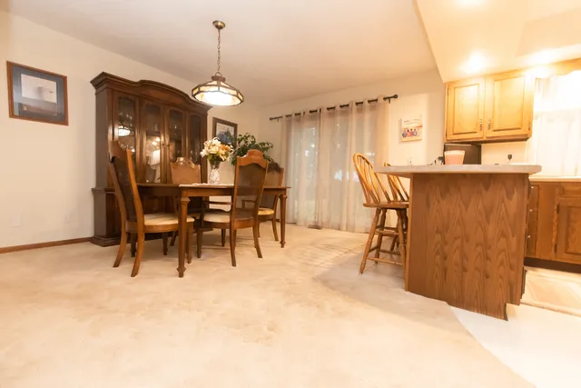 a view of a dining room with furniture and chandelier