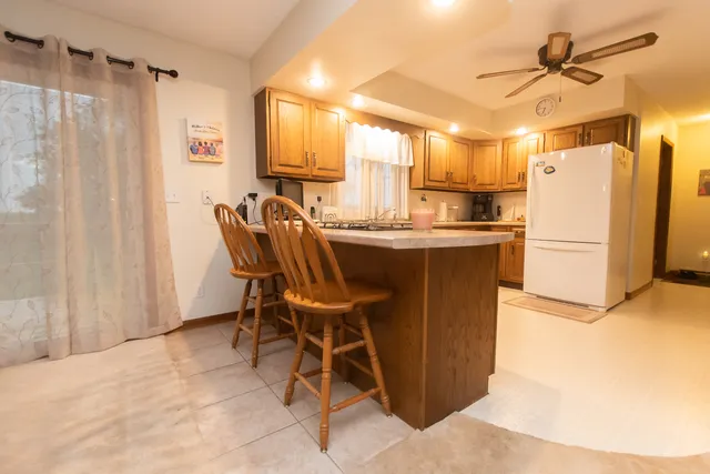 a dining table chair next to a window