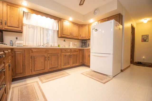 a kitchen with stainless steel appliances granite countertop a refrigerator and a sink