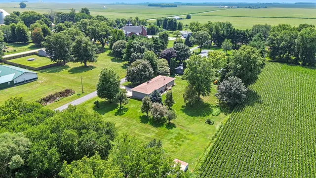 an aerial view of a house with a yard