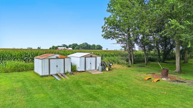 a view of a house with backyard and sitting area