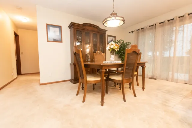 a view of a dining room with furniture and window