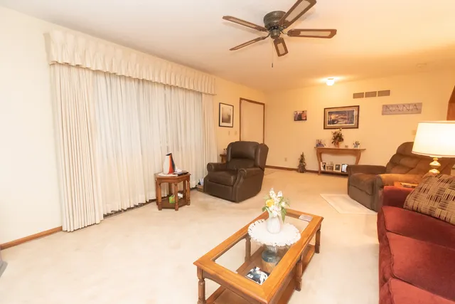 a living room with furniture a couch and a window