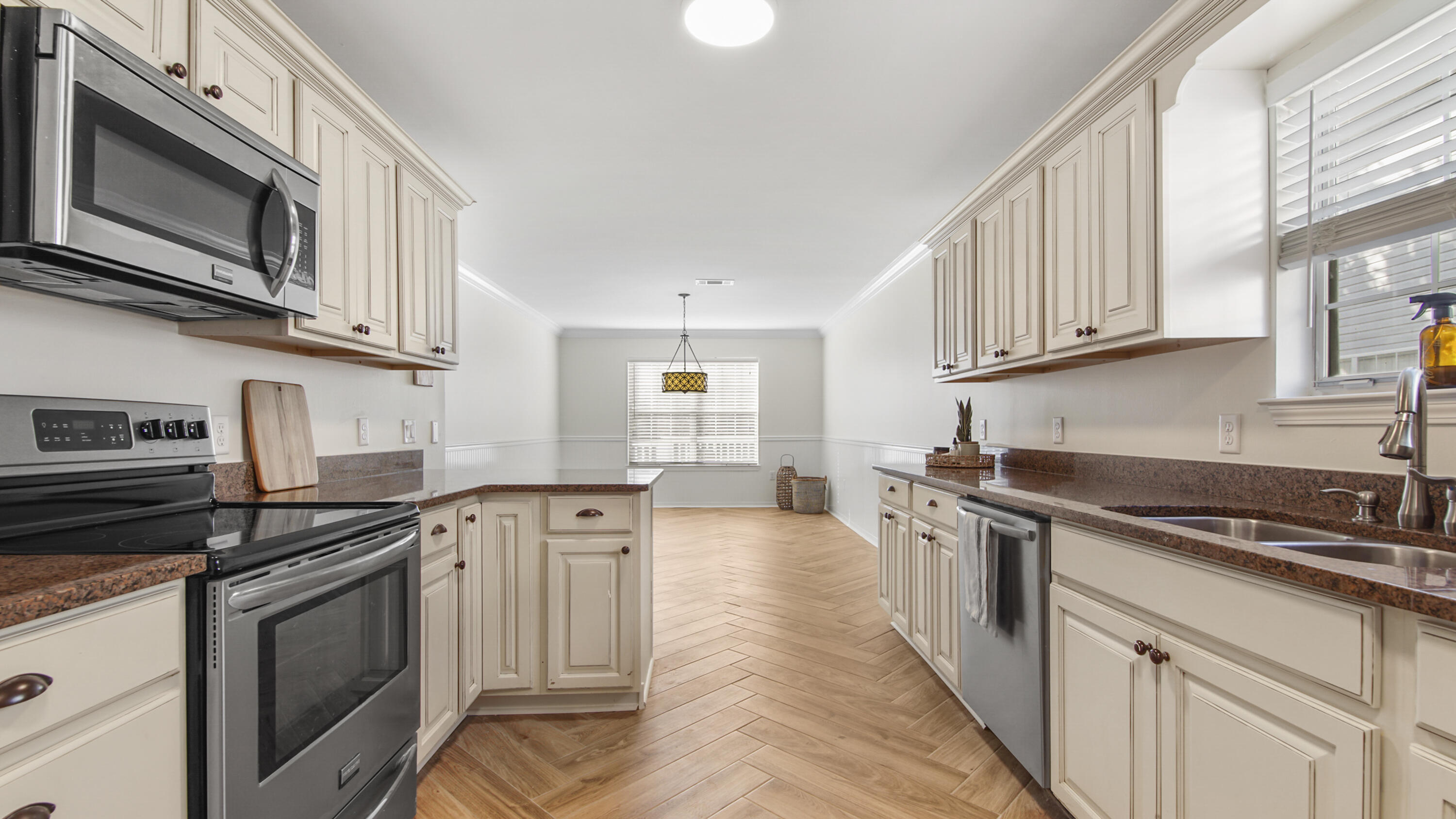 302 Liriope Loop Destin, FL 32541 - Photo 11 of 59 a kitchen with stainless steel appliances a stove sink microwave and cabinets