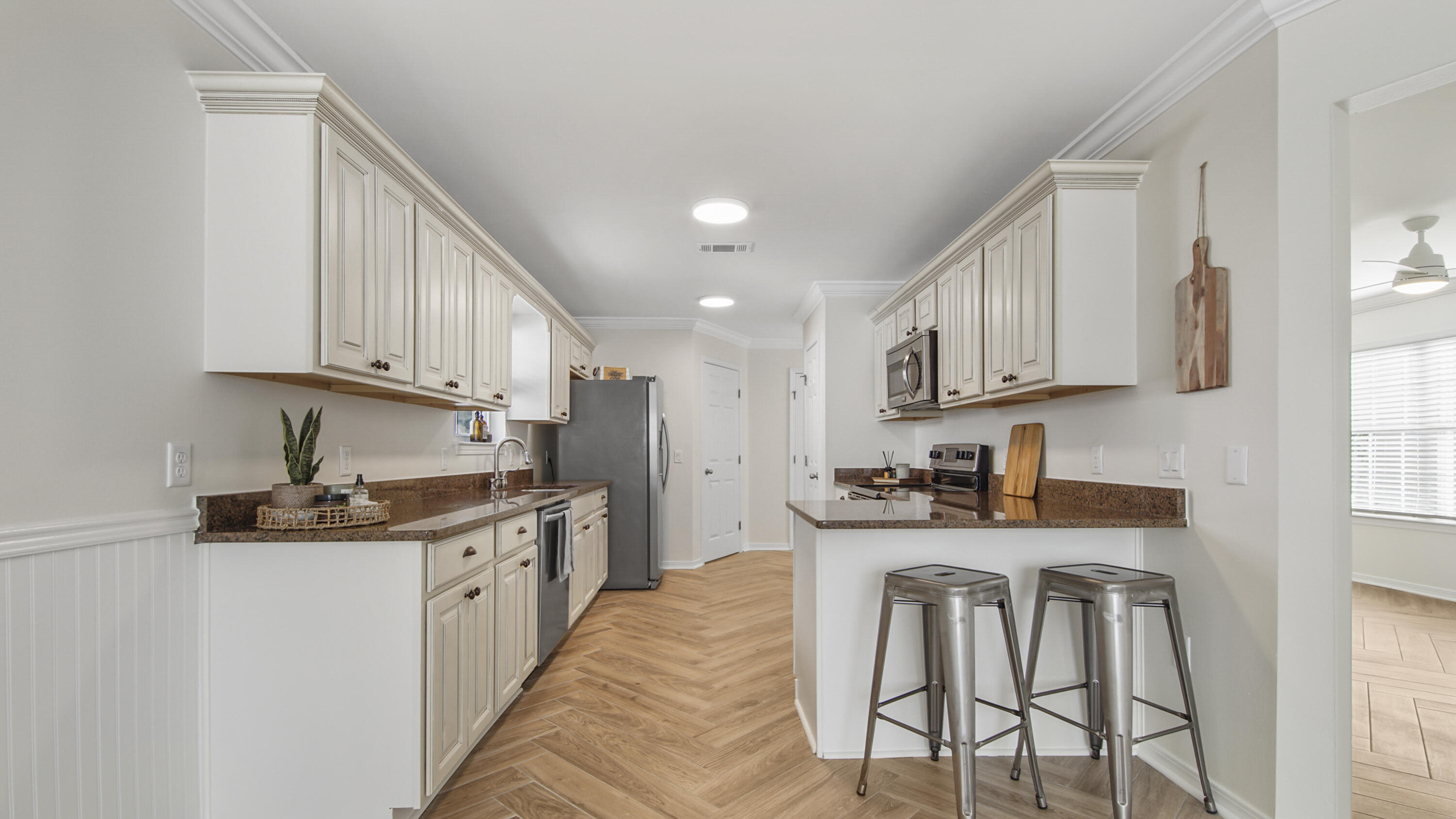 302 Liriope Loop Destin, FL 32541 - Photo 12 of 59 a kitchen with stainless steel appliances kitchen island granite countertop a sink and cabinets