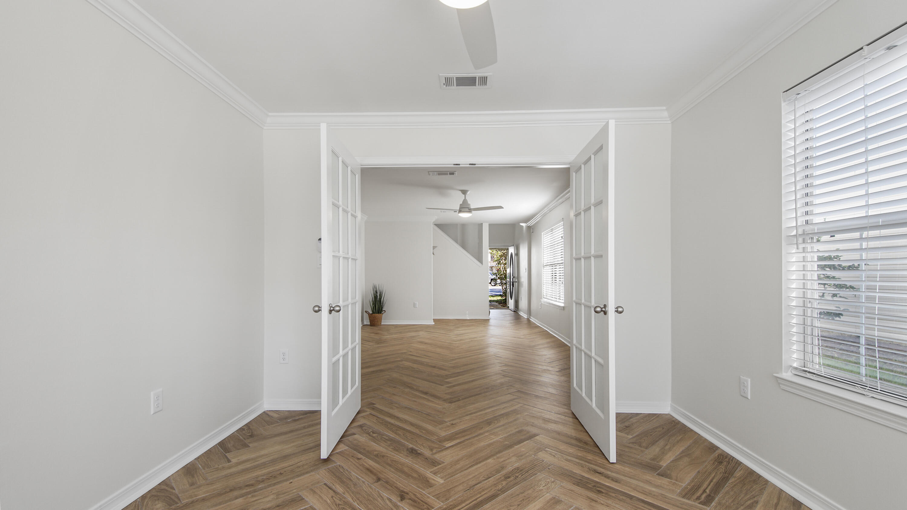 302 Liriope Loop Destin, FL 32541 - Photo 17 of 59 a view of a hallway with wooden floor and a bathroom