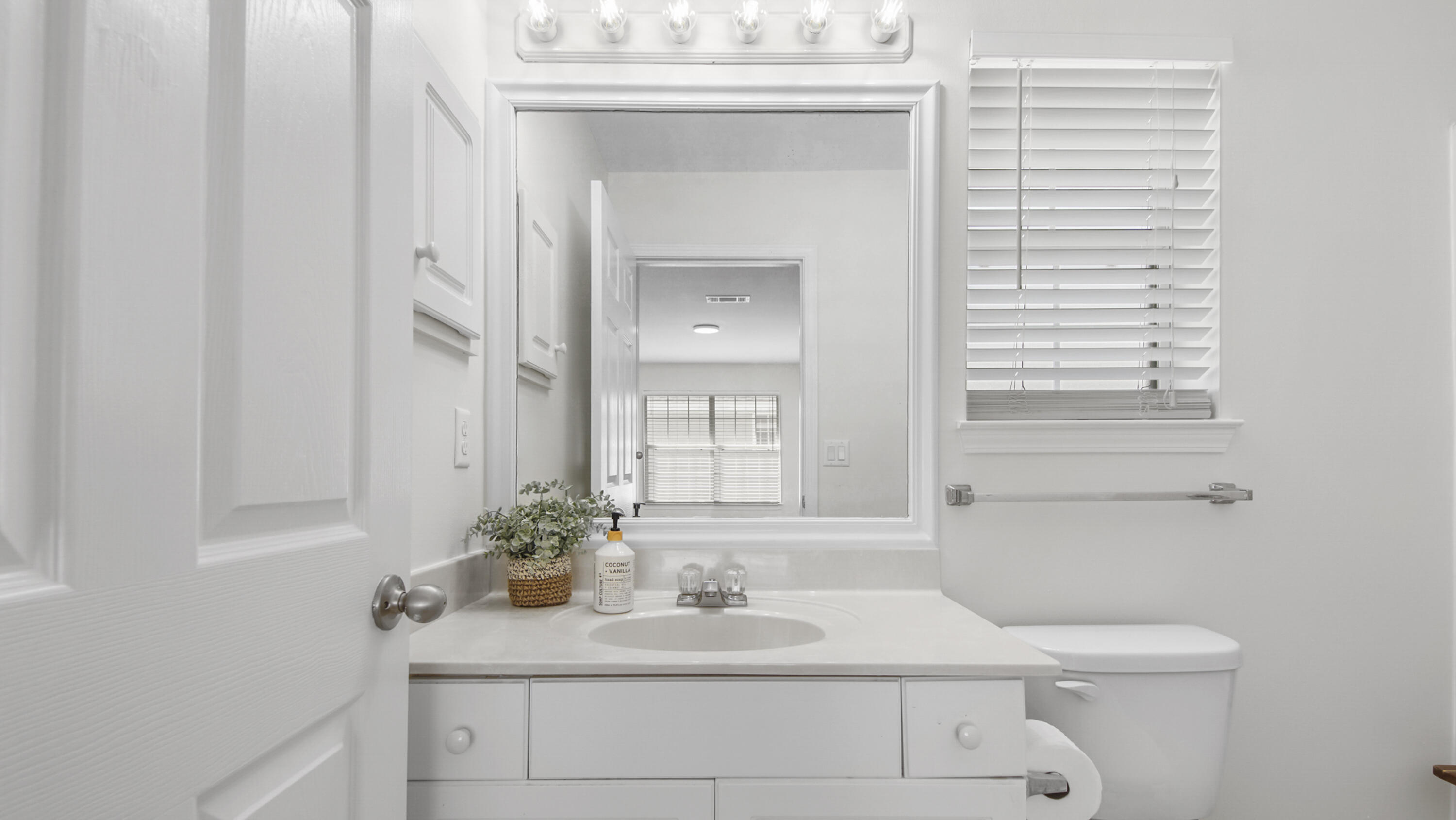 302 Liriope Loop Destin, FL 32541 - Photo 28 of 59 a bathroom with a sink and a mirror