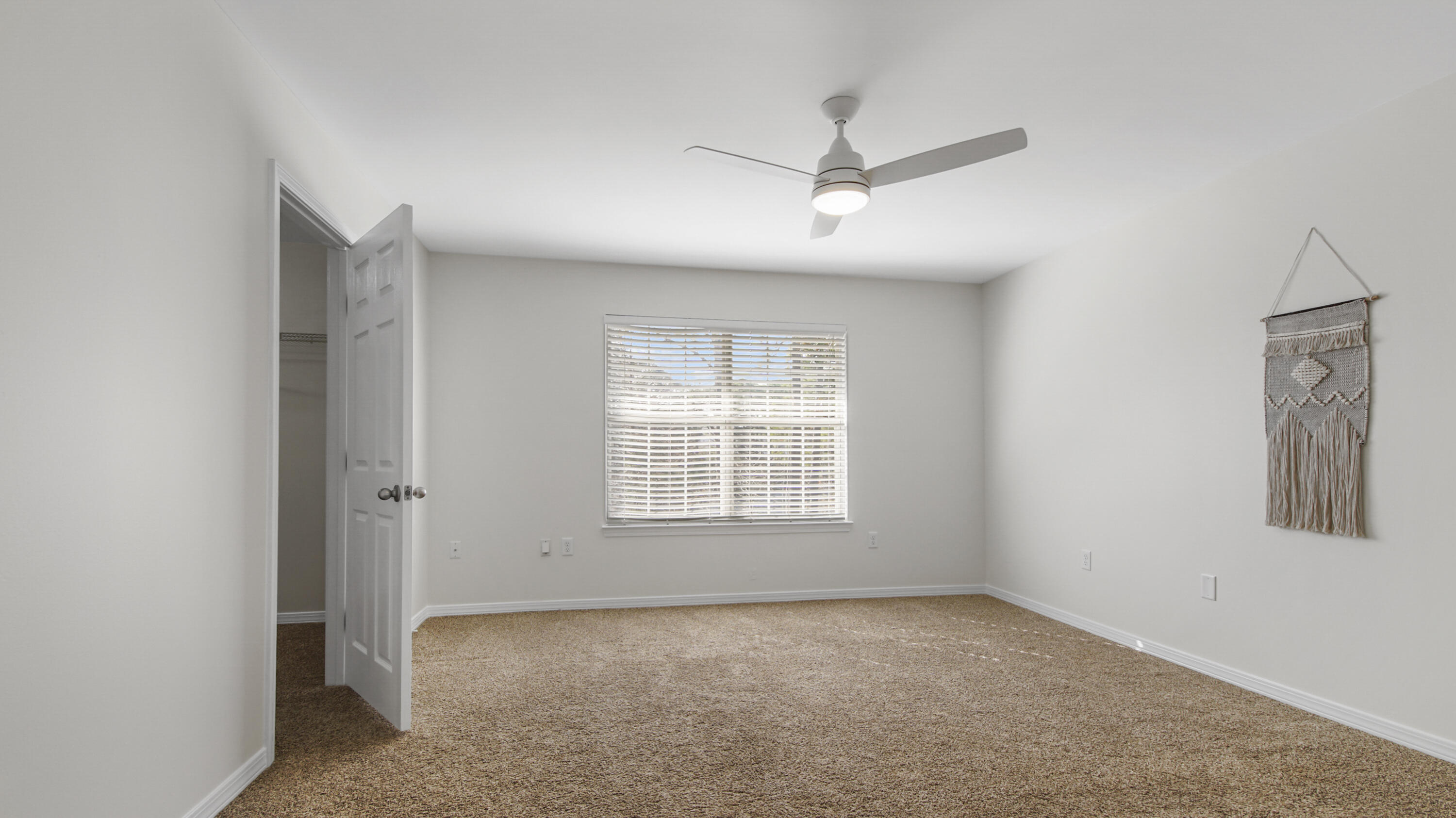 302 Liriope Loop Destin, FL 32541 - Photo 33 of 59 a view of a big room with windows and chandelier fan