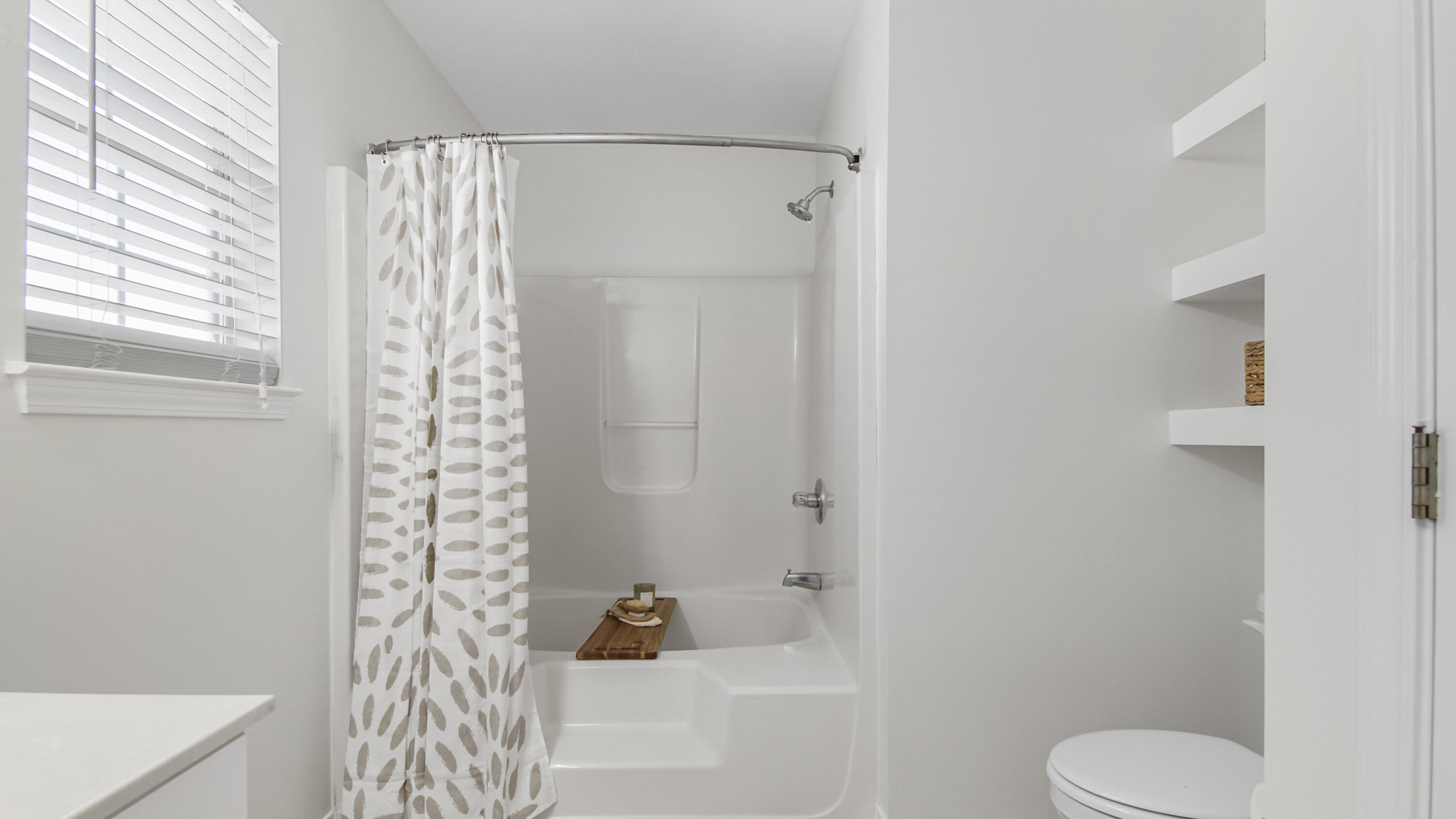 302 Liriope Loop Destin, FL 32541 - Photo 37 of 59 a bathroom with a toilet and shower curtain