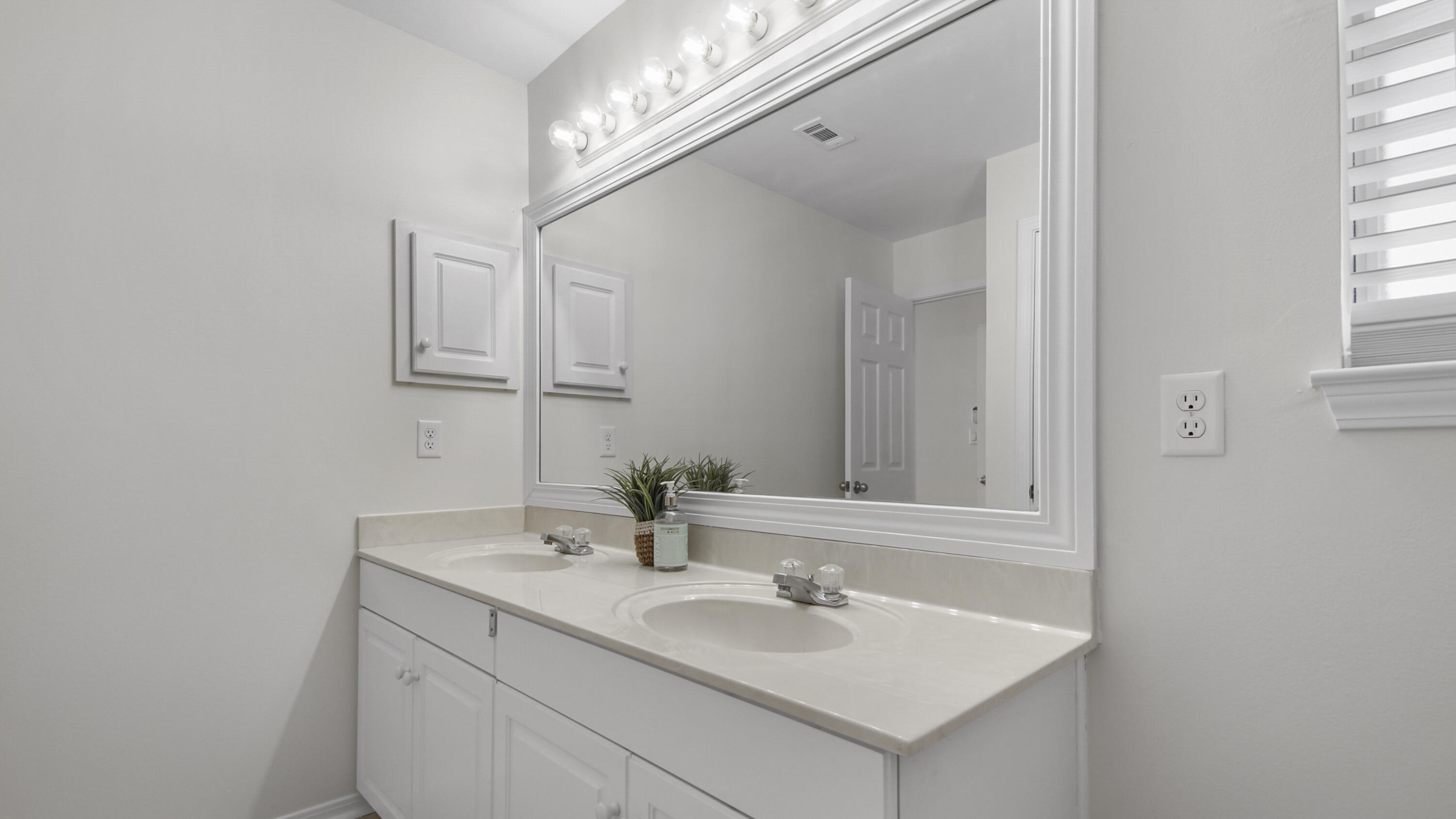 302 Liriope Loop Destin, FL 32541 - Photo 38 of 59 a bathroom with a sink and a mirror