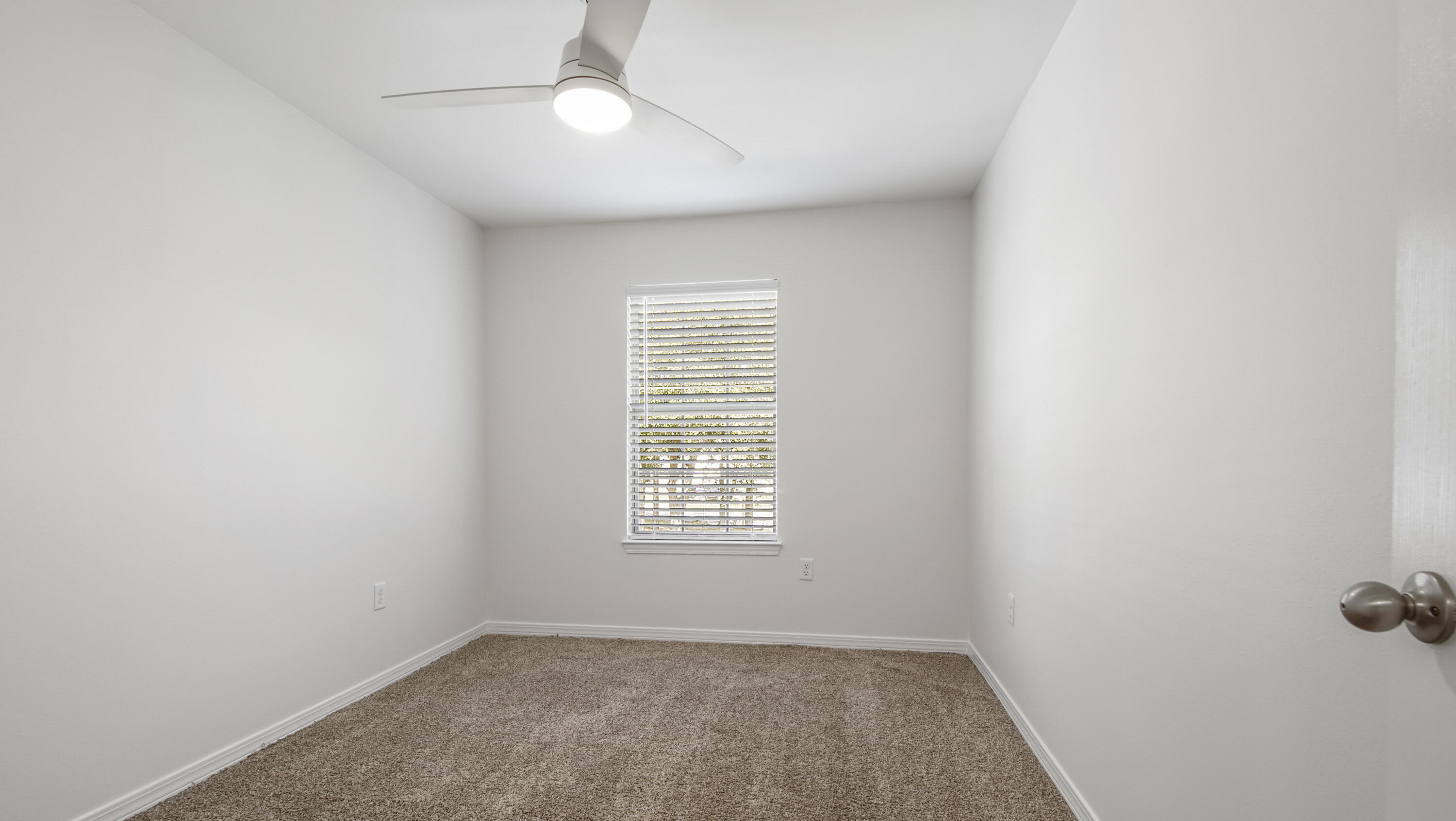 302 Liriope Loop Destin, FL 32541 - Photo 43 of 59 an empty room with windows and fan