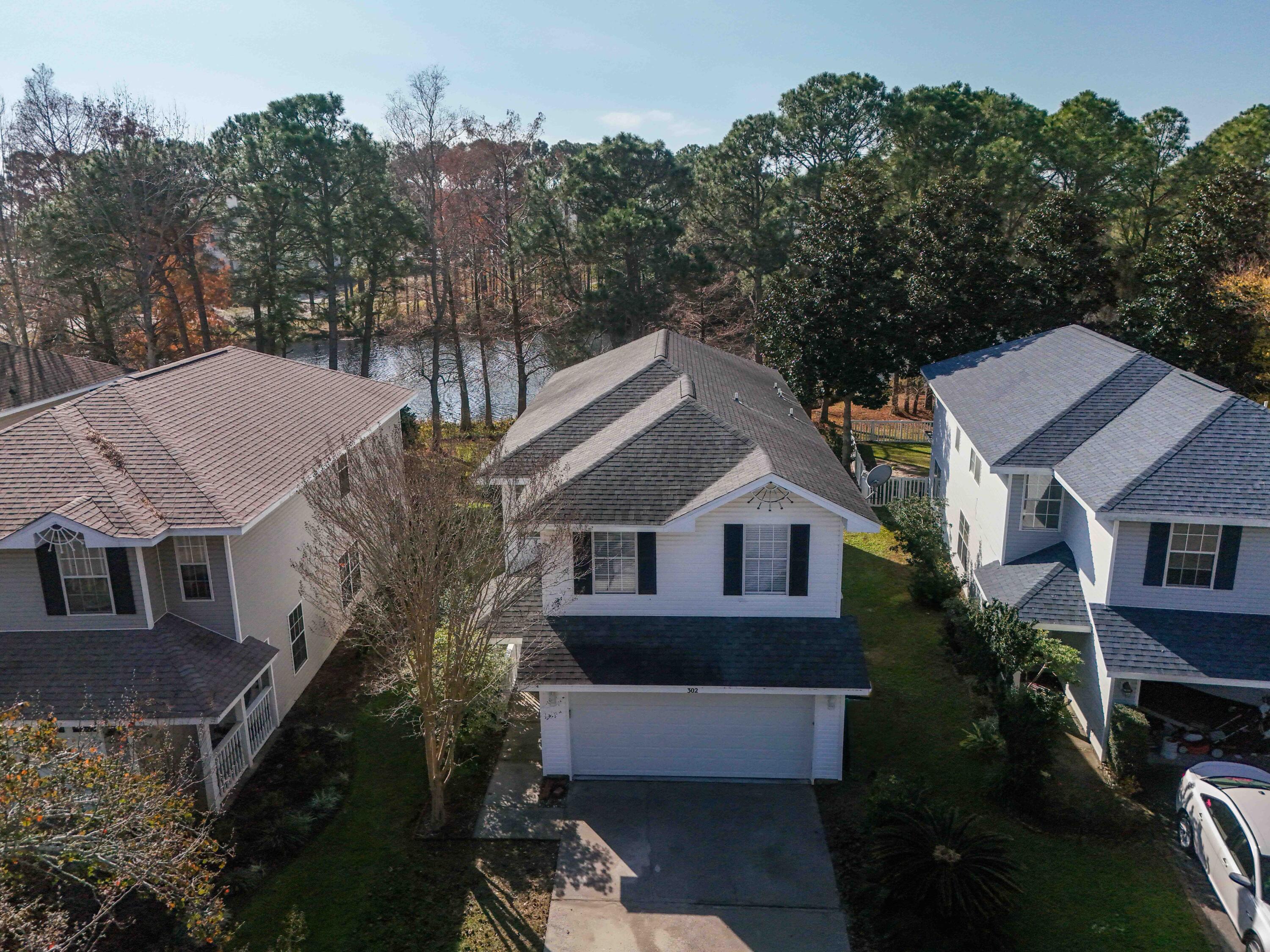 302 Liriope Loop Destin, FL 32541 - Photo 58 of 59 a aerial view of a house with a yard and potted plants