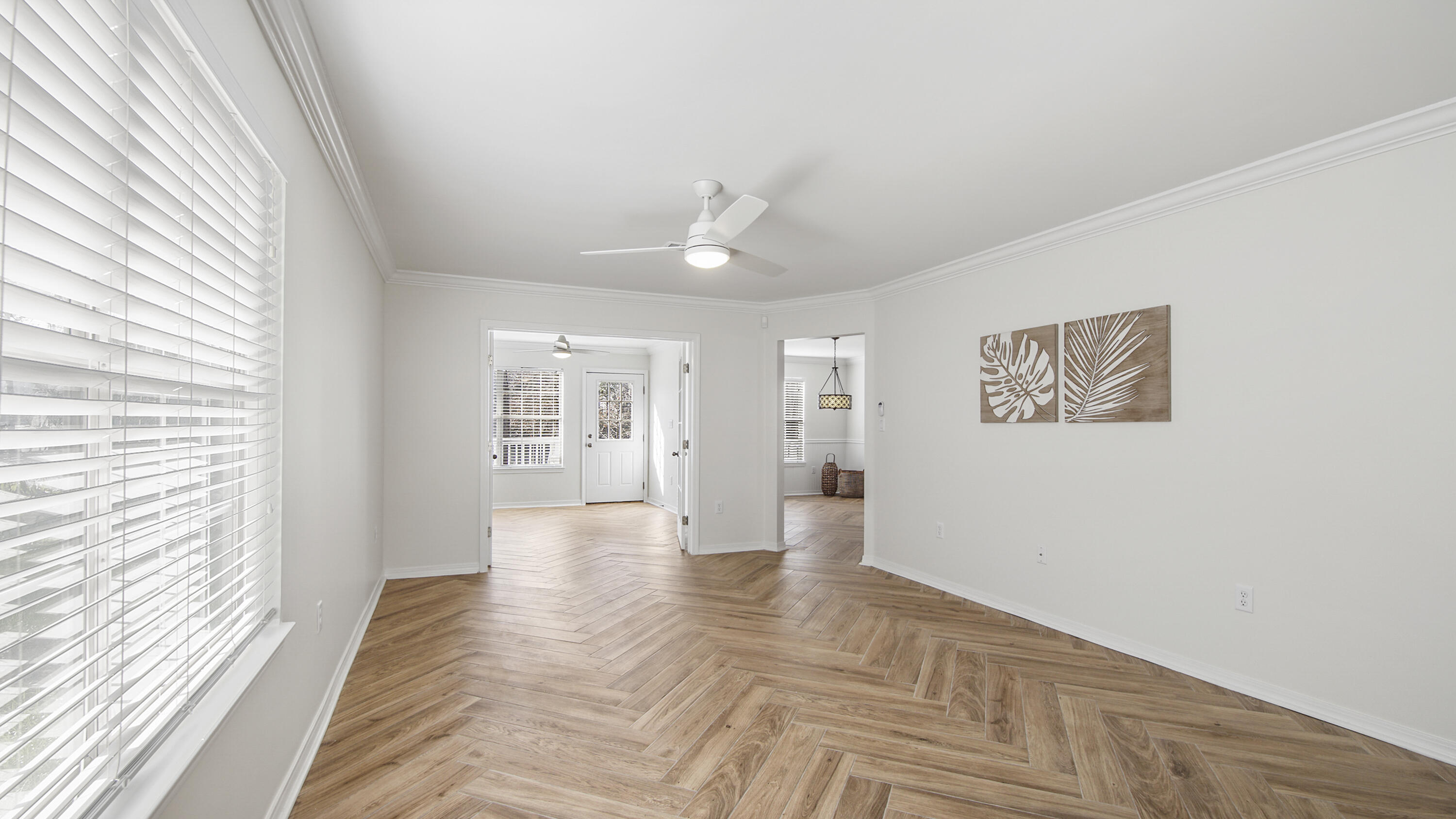 302 Liriope Loop Destin, FL 32541 - Photo 8 of 59 a view of an empty room with wooden floor and a window